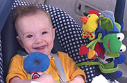 Mika enjoying new car-seat toys